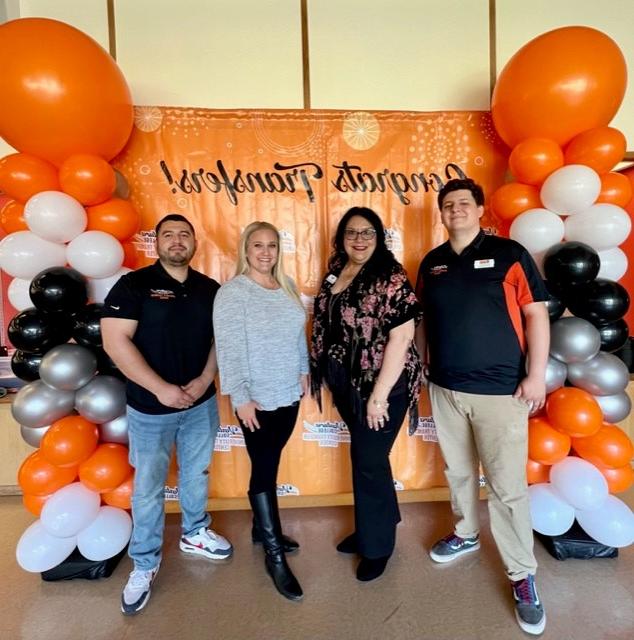 UniversityTransfer Center Staff standing in front of center backdrop with balloon columns on either side