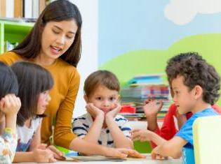 A female instructor talking to young children.