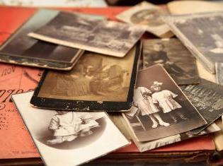 A stack of old sepia toned photographs.