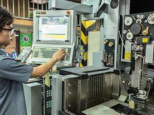 A manufacturing machine being serviced by a technician.