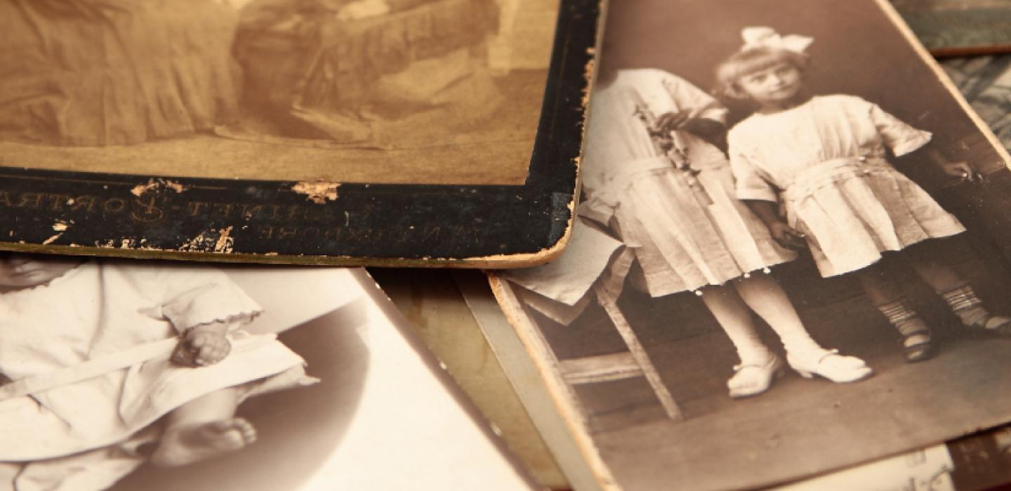 A stack of old sepia toned photographs.